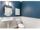 Powder room with pedestal sink, white wainscoting, and blue walls at 1658 Duncan Nw Dr, Atlanta, GA 30318