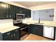 Updated kitchen featuring dark cabinetry and quartz countertops at 2901 Lenox Ne Rd # 901, Atlanta, GA 30324