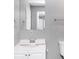 Well-lit bathroom with a single sink vanity, large mirror, and grey wall at 2222 Mcafee Rd, Decatur, GA 30032