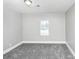 Bedroom featuring a plush carpet, a window with natural light, and neutral paint at 2222 Mcafee Rd, Decatur, GA 30032