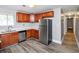 Galley kitchen with stainless steel appliances, wood cabinets and laminate flooring at 2222 Mcafee Rd, Decatur, GA 30032