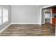 Open-concept living room showcasing the laminate wood flooring and ample natural light at 2222 Mcafee Rd, Decatur, GA 30032
