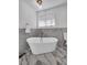 Elegant bathroom with a modern tub, stylish fixtures and marble accents at 2645 Shadow Woods Ne Cir, Marietta, GA 30062