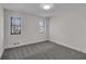 Bright bedroom with neutral carpet, black framed windows, and ample natural light at 2645 Shadow Woods Ne Cir, Marietta, GA 30062
