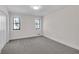 Bright bedroom with neutral carpet, black framed windows, and ample natural light at 2645 Shadow Woods Ne Cir, Marietta, GA 30062