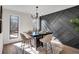 Elegant dining area with modern decor, stylish lighting, designer wall, and views of the landscape at 2645 Shadow Woods Ne Cir, Marietta, GA 30062