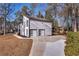 Contemporary home features two garage doors and side entry on a sunny day at 2645 Shadow Woods Ne Cir, Marietta, GA 30062