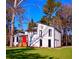 Striking white exterior elevation featuring a red front door and modern architectural details in wooded setting at 2645 Shadow Woods Ne Cir, Marietta, GA 30062