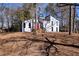 Beautiful home with a red front door, surrounded by mature trees in a serene setting at 2645 Shadow Woods Ne Cir, Marietta, GA 30062