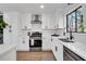 White kitchen with stainless steel appliances and herringbone backsplash at 2645 Shadow Woods Ne Cir, Marietta, GA 30062