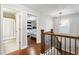 Upstairs hallway with hardwood floors and access to bedrooms at 3230 Harmony Hill Trce, Kennesaw, GA 30144