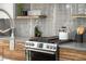 Modern kitchen with gray tile backsplash and wood cabinets at 426 Arnold Ne St, Atlanta, GA 30308