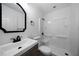 Clean bathroom with white vanity, shower, and black accents at 4770 Shady Rest Dr, Powder Springs, GA 30127