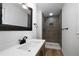 Modern bathroom with gray tile shower and updated vanity at 4770 Shady Rest Dr, Powder Springs, GA 30127