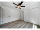 Well-lit bedroom featuring wood-look floors and ample closet space at 4770 Shady Rest Dr, Powder Springs, GA 30127