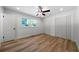 Bright bedroom with wood-look floors, double closets, and ceiling fan at 4770 Shady Rest Dr, Powder Springs, GA 30127