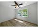 Spacious bedroom with large windows, ceiling fan, and wood-look floors at 4770 Shady Rest Dr, Powder Springs, GA 30127