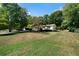 Single story home with a spacious front yard and trees at 4770 Shady Rest Dr, Powder Springs, GA 30127