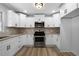 Renovated kitchen, featuring white cabinets and stainless steel appliances at 4770 Shady Rest Dr, Powder Springs, GA 30127