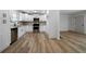 Modern kitchen with white cabinets, stainless steel appliances, and light wood flooring at 4770 Shady Rest Dr, Powder Springs, GA 30127