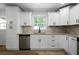 Modern kitchen with white cabinets, granite countertops, and stainless steel appliances at 4770 Shady Rest Dr, Powder Springs, GA 30127