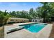 Inviting pool with diving board, wooden deck, and storage shed at 4770 Shady Rest Dr, Powder Springs, GA 30127