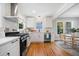 Modern white kitchen with stainless steel appliances and hardwood floors at 1183 Cahaba Dr, Atlanta, GA 30311