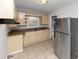 Bright kitchen with light cabinets and stainless steel refrigerator at 1368 Wichita Sw Dr, Atlanta, GA 30311