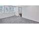 Finished basement room with grey carpet and hardwood floor access at 1641 Pinehurst Sw Dr, Atlanta, GA 30311