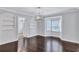 Spacious dining room featuring hardwood floors and built-in shelving at 1641 Pinehurst Sw Dr, Atlanta, GA 30311