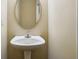 Simple bathroom with pedestal sink and oval mirror at 2916 Hillside Pl, Decatur, GA 30034