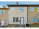 Townhouse exterior with light-beige siding and white door at 2916 Hillside Pl, Decatur, GA 30034