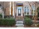 Townhome entrance with brick steps, landscaping, and a dark brown door at 3156 Neal Ct, Cumming, GA 30041