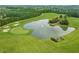 Aerial view of a lush green golf course with a pond at 3156 Neal Ct, Cumming, GA 30041