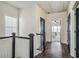 Upstairs hallway with dark doors and hardwood floors at 3156 Neal Ct, Cumming, GA 30041