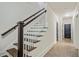 Modern staircase with dark wood railings and white balusters at 3156 Neal Ct, Cumming, GA 30041