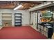 Unfinished basement featuring carpeted floor and shelving units, offering potential for storage or renovation at 5659 Brookstone Nw Dr, Acworth, GA 30101