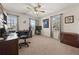 Bedroom featuring neutral walls, carpet, ceiling fan, and a desk area with natural light from dual windows at 5659 Brookstone Nw Dr, Acworth, GA 30101