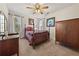 Bedroom with neutral carpet, ceiling fan, windows, and traditional furniture including a bed and dresser at 5659 Brookstone Nw Dr, Acworth, GA 30101