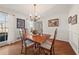 Bright dining room with hardwood floors, chandelier, and wainscoting at 5659 Brookstone Nw Dr, Acworth, GA 30101