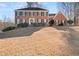 Brick two-story house with a large front yard and mature trees at 5659 Brookstone Nw Dr, Acworth, GA 30101