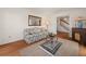 Living room with hardwood floors, floral sofa, and ornate mirror at 5659 Brookstone Nw Dr, Acworth, GA 30101