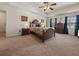 Spacious main bedroom with tray ceiling, fan, and large windows at 5659 Brookstone Nw Dr, Acworth, GA 30101