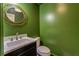 Stylish powder room featuring a dark vanity, marble countertop, and green walls at 2439 Woodridge Dr, Decatur, GA 30033