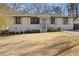 Charming ranch home with white brick exterior, landscaping, and a welcoming front porch at 2439 Woodridge Dr, Decatur, GA 30033