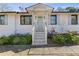 Renovated front entry with light gray door and white columns at 2439 Woodridge Dr, Decatur, GA 30033