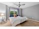 Bright bedroom featuring a king-size bed and a window with wooded views at 2680 Pine Tree Ne Rd # 2, Atlanta, GA 30324