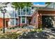 Two-story townhouse with brick and gray siding, double garage, and manicured landscaping at 2680 Pine Tree Ne Rd # 2, Atlanta, GA 30324