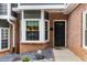 Inviting front entrance to a townhome with a black door and bay window at 2680 Pine Tree Ne Rd # 2, Atlanta, GA 30324