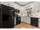 Modern kitchen with white cabinets, black appliances, and quartz countertops at 2680 Pine Tree Ne Rd # 2, Atlanta, GA 30324